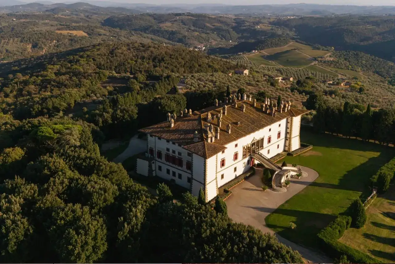 Villa toscana immersa nel verde, con vigneti e uliveti, ideale per degustare un ottimo Carmignano vino.